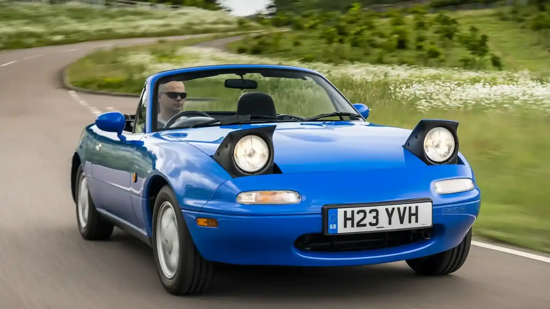Inspired by post-war British sports cars, the Mazda MX-5 Miata reignited global enthusiasm for open-top roadsters after classics like the MG B, Triumph Spitfire, and Fiat 124 Spider had disappeared from the market.