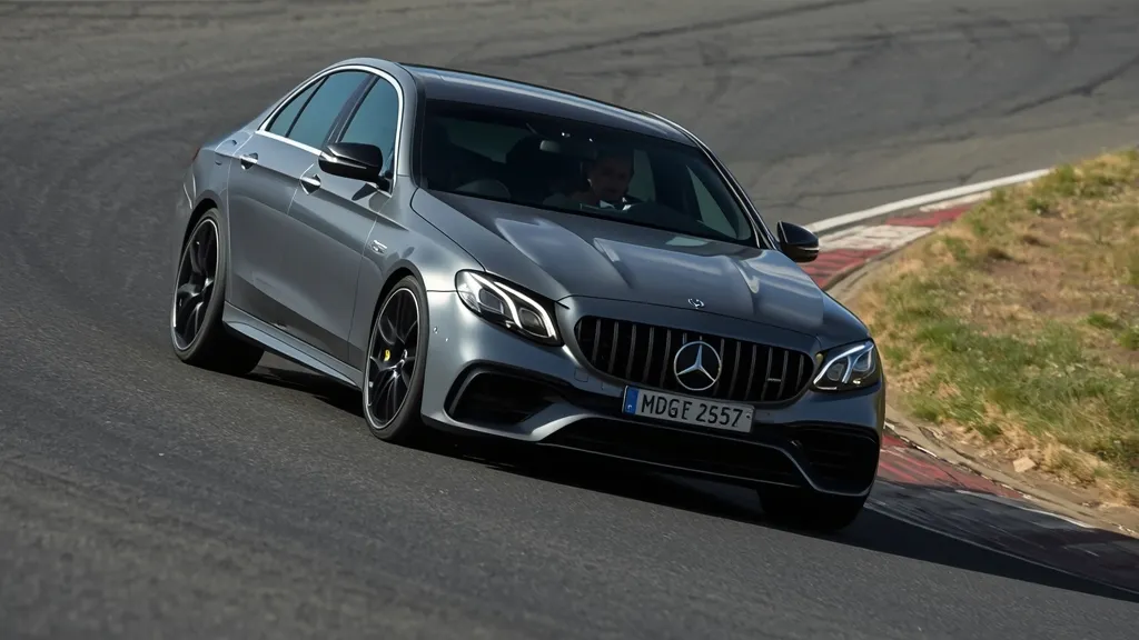 AMG E53 4Matic+ cornering on a race track, demonstrating its agile handling and 4Matic+ grip.