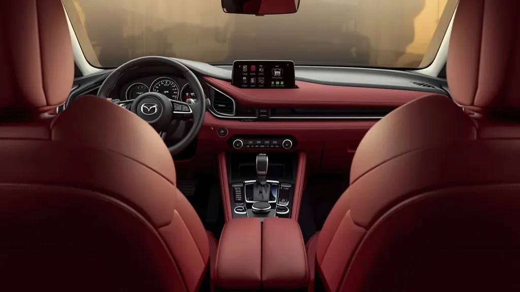 Luxurious interior of 2023 Mazda 3, featuring premium red leather seats and driver-focused cockpit.
