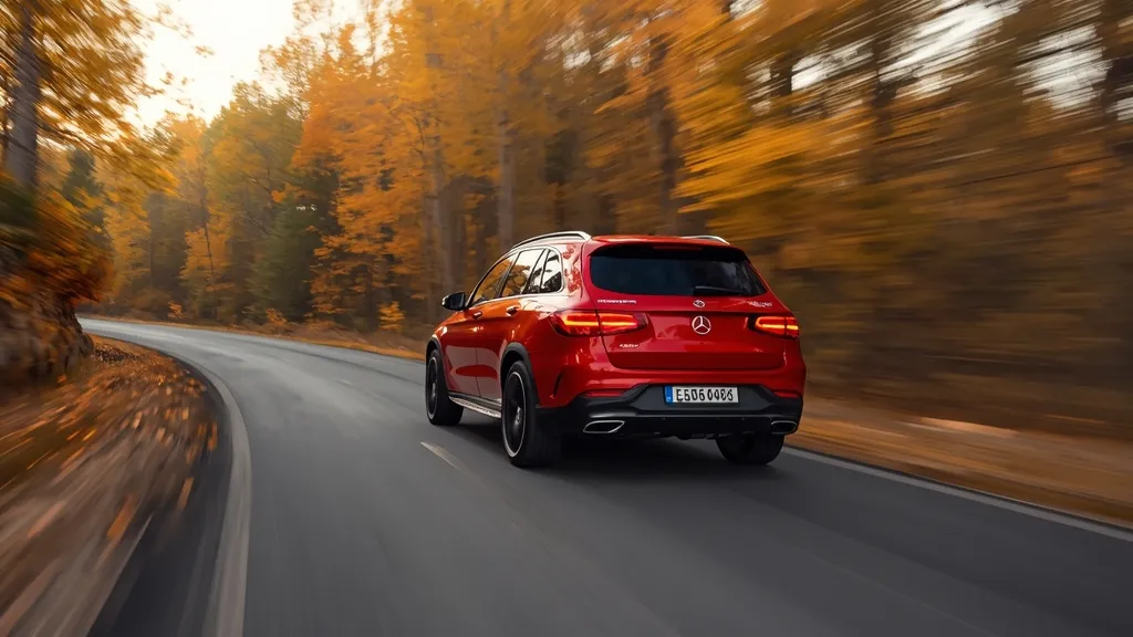 An action shot of the previous generation Mercedes-AMG GLC 43 with its twin-turbo V6, driving on a scenic mountain road.